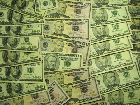 A number of 50 and 100 dollar bills spread out as a background.