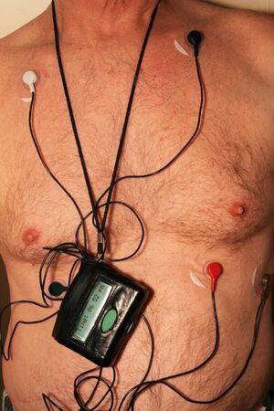 torso of old man wearing a 5 lead cardiac monitor harnessの写真素材