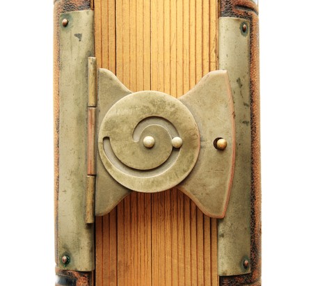brass spiral book clasp detail from an antique photography album with gilded pages and leather coverの写真素材