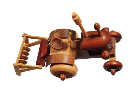top front view of a wooden tractor with disk plow toy isolated on whiteの写真素材