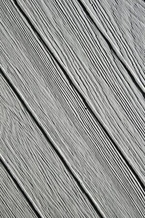 background of diagonal gray painted wooden boards with side lightingの写真素材