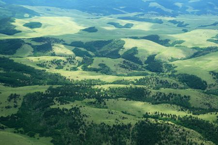aerial photo of hills in Colorado with green fields and treesの写真素材