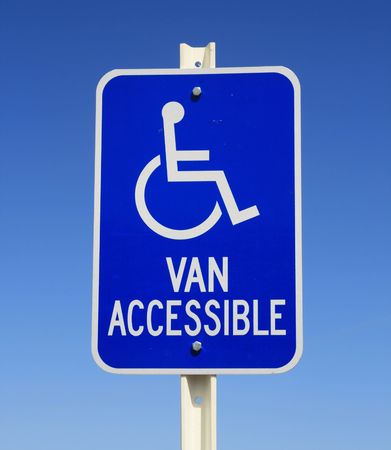 handicapped van parking sign in blue and white on blue sky backgroundの写真素材