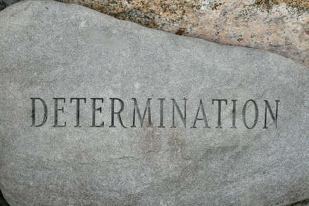 the word determination carved onto a granite cobble stoneの写真素材