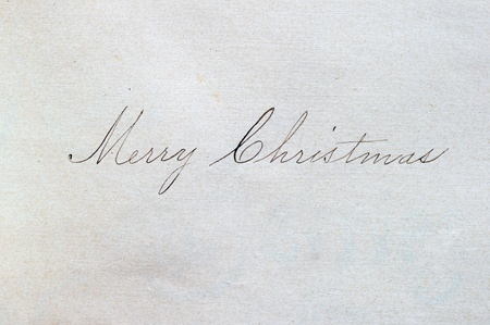 Merry Christmas written in cursive script on paper with an ink penの写真素材