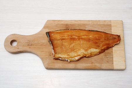 smoked trout on a wooden cutting boardの写真素材