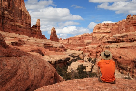 a sitting man admires the view in Canyonlands National Parkの写真素材