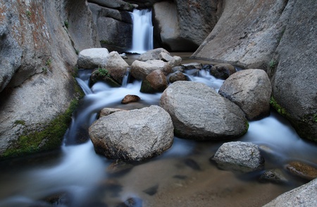 silky smooth waterfall in the carved granite canyon of McGee Creekの写真素材