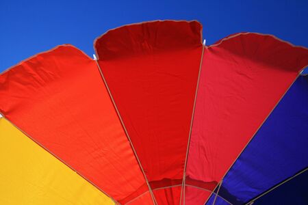 colorful beach umbrella edge with blue sky backgroundの写真素材