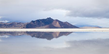 reflection of distant mountains in a pool in the Bonneville Salt Flats