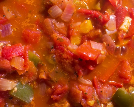 homemade tomato sauce with vegetables simmering on a stove topの写真素材