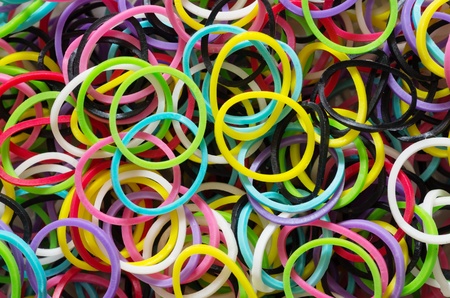 macro background image of many small colorful rubber bands