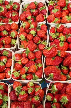 fresh strawberries in baskets for sale at a farmers marketの写真素材