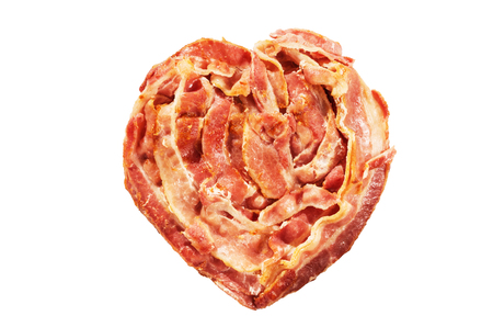 cooked bacon heart shape isolated on white backgroundの写真素材