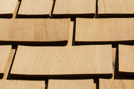 new wooden cedar roof shingles detail on a roofの写真素材