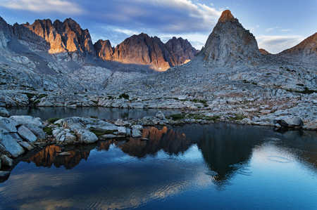 evening reflection of Isosceles and Mount Winchell and Thunderbolt in an alpine lake in Dusy Basin of the Sierra Nevada Mountainsの写真素材