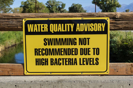 water quality advisory sign warning against swimming due to high bacteria levelsの写真素材