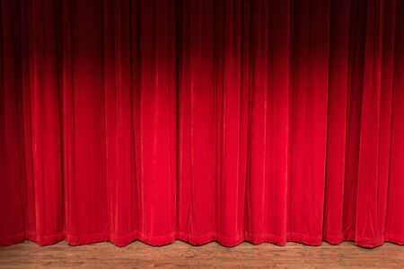 wood stage with closed red curtains with shadow at the topの写真素材