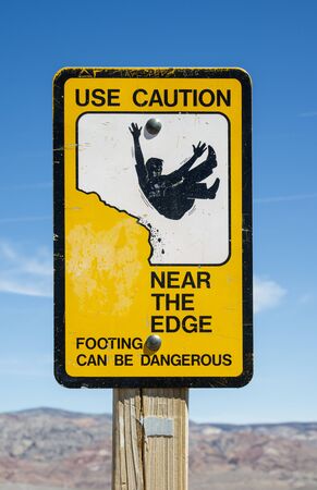 use caution near the edge warning sign at overlookの写真素材