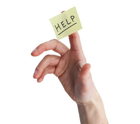 hand with yellow note stuck to finger with help on it isolated on whiteの写真素材