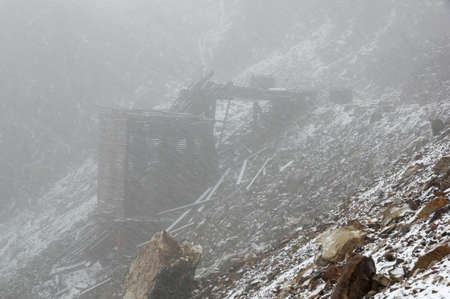 Old Adamson Mine Ruins in a summer Sierra snowstormの写真素材