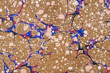 vintage brown red and blue marbled paper backgroundの写真素材