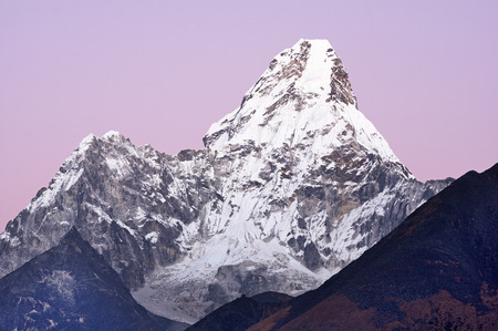 6170 meter tall Ama Dablam Mountain as seen from Tengboche Monastary just after sunset with pale purple skyの写真素材