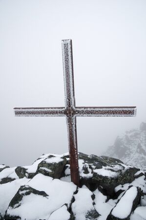 the Blanca Peak summit cross covered in rime ice in a whiteoutの写真素材