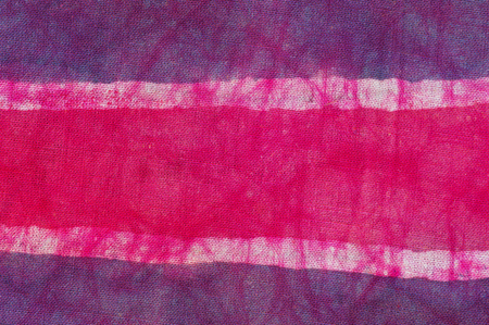 batik cloth with purple white and pink stripesの写真素材