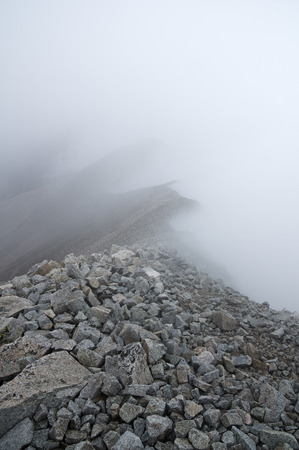 Mount Antero rocky ridge obscured by foggy cloudsの写真素材