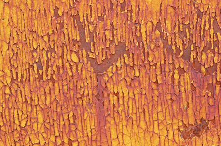 cracked and flaky yellow paint on a rusty metal backgroundの写真素材