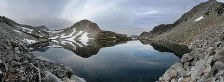 panorama of Golden Lake in the Sierra Nevada Mountains of California on a cloudy dayの写真素材