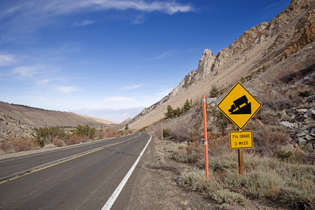 steep downhill with 7 percent grade sign on a mountain roadの写真素材