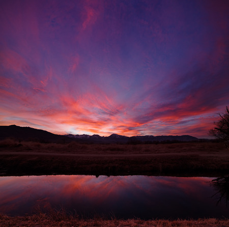 sunset in the Owens Valley near Bishop California with an irrigation canalの写真素材