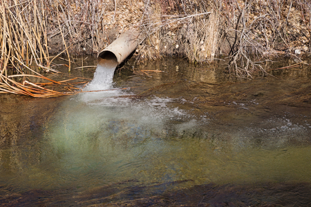 groundwater water flows from a pipe into the North Fork of Bishop Creekの写真素材