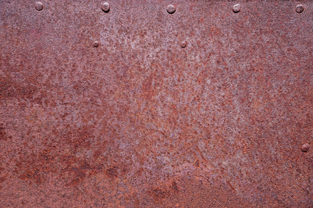 rusty metal background with a few rivetsの写真素材