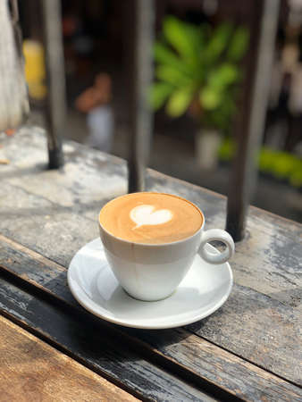 Hot coffee cup with heart latte artの写真素材