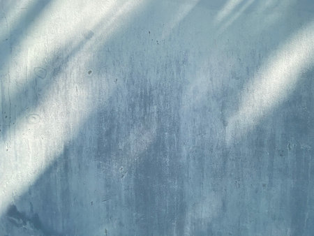Grunge blue concrete wall texture with shadow. Abstract background.の写真素材