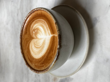 Cup of cappuccino with latte artle backgroundの写真素材