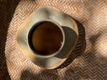 Coffee cup on the table in the morning sun light.の写真素材
