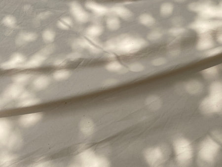 shadow on a white fabric as a background, closeup of photoの写真素材