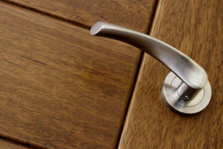 Handle and wooden door close upの写真素材