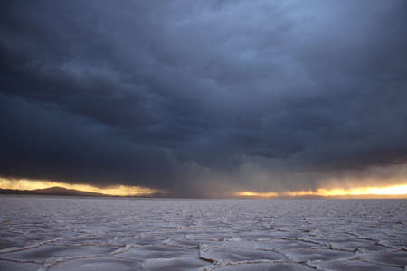 Storm at salt flat desert on sunsetの写真素材