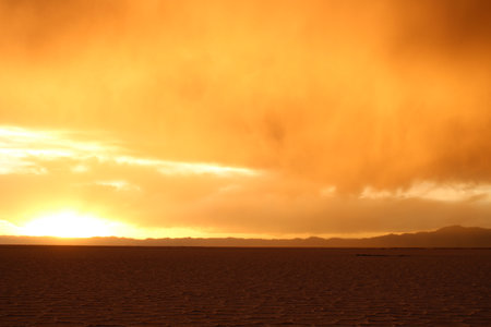 Storm at salt flat desert on sunsetの写真素材