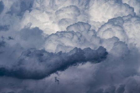 powerful and active white cumulonimbus cloud in a deep blue skyの写真素材