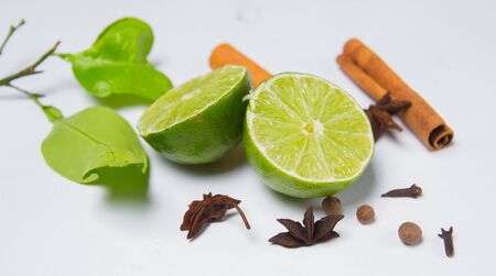 lemon slice and spices on white table black backgroundの写真素材