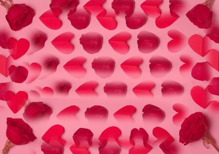 red roses and paper hearts in pink background concept of love or valentines day with copy spaceの写真素材