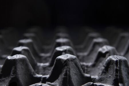 black and white empty eggs carton or box showing shape,light,perspective and shadow patternsの写真素材