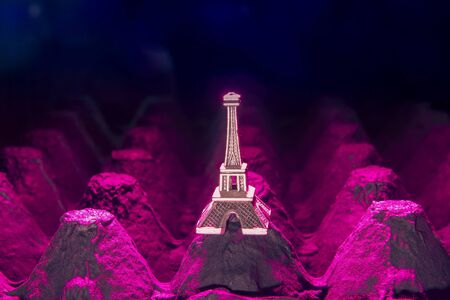 colorful empty eggs carton or box showing shape,light and shadow patterns and small eiffel towerの写真素材