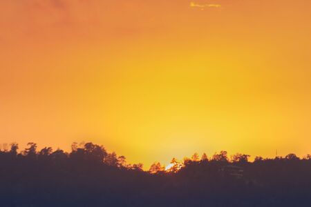 sunset orange and yellow cumulus clouds in a summer dayの写真素材